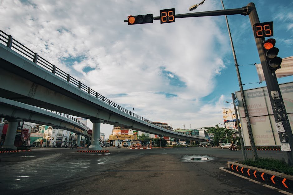 Low angle of empty asphalt crossroad with red traffic light with timer in center of city
